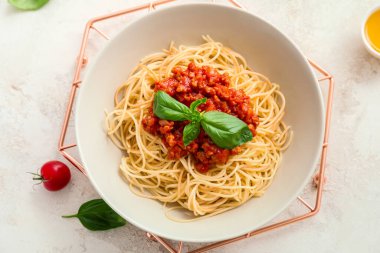 Plate with tasty pasta bolognese on table