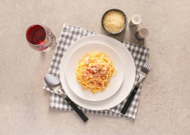 Plate with tasty pasta carbonara on grey background