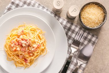 Plate with tasty pasta carbonara on grey background