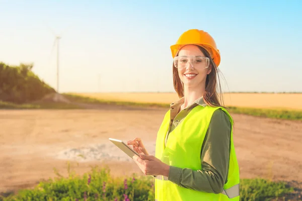 Female engineer on windmill farm for electric power production