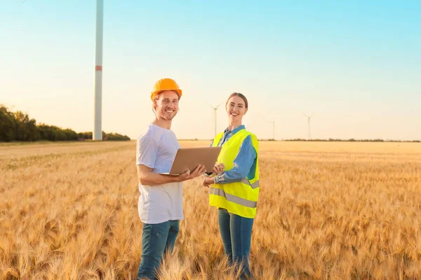 Engineers on windmill farm for electric power production