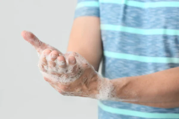 Man washing hands with soap, closeup