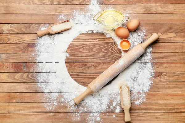 Composition with rice flour and products on wooden background