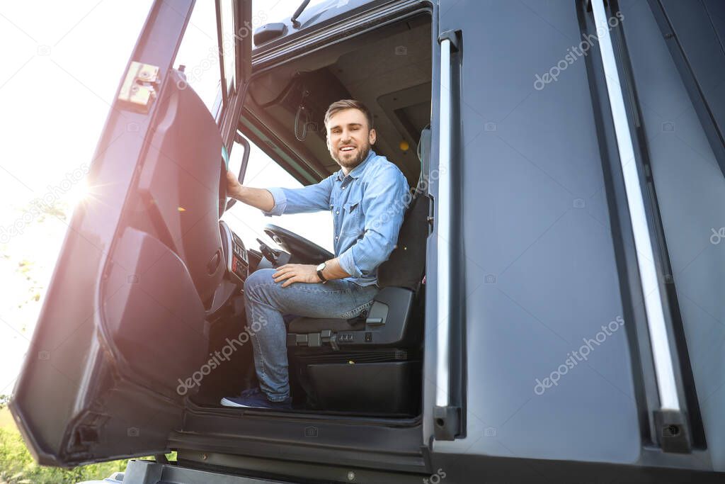 Male driver in cabin of big truck