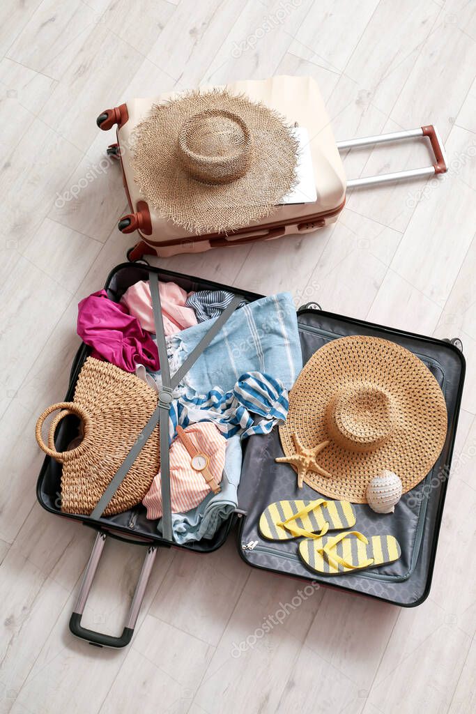Packed suitcases on wooden background. Travel concept