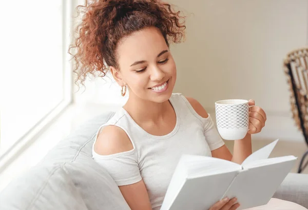 Beautiful Young African American Woman Book Drinking Hot Tea Home — Stock Photo, Image
