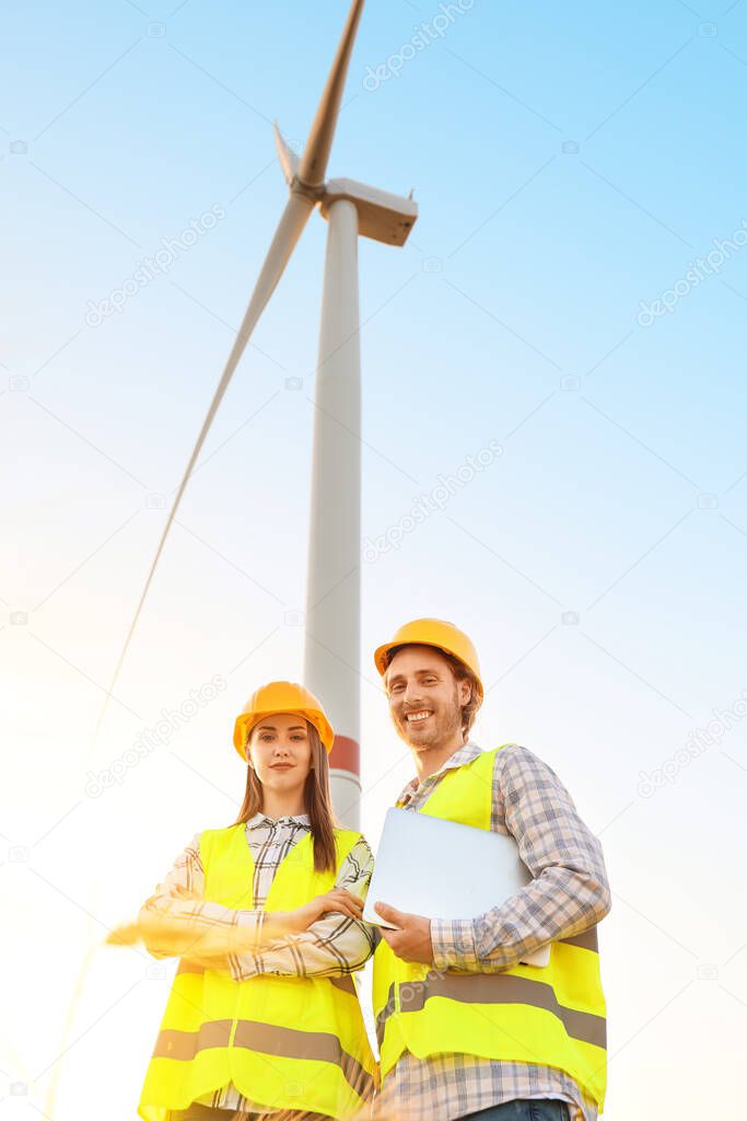 Engineers on windmill farm for electric power production