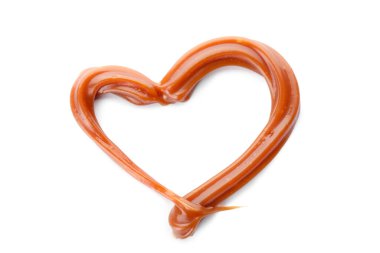 Beyaz zemin üzerinde sıvı karamelden yapılmış kalp.