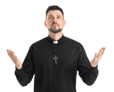 Beyaz arka planda yakışıklı dua eden rahip.