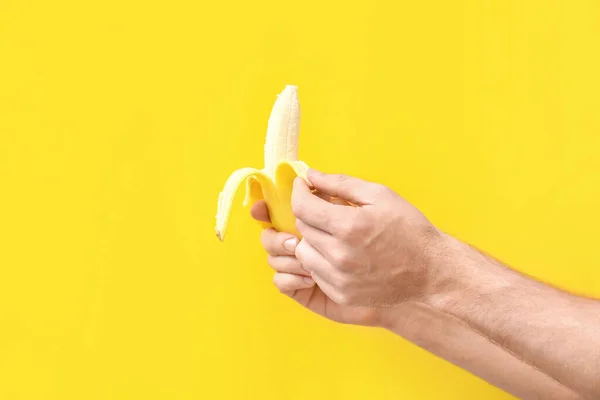 Man Peeling Banana Color Background — Stock Photo, Image