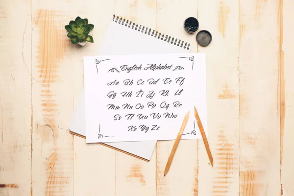 Cuaderno Hoja Papel Con Alfabeto Tinta Sobre Mesa —  Fotos de Stock