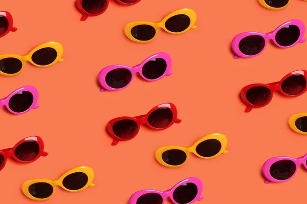 Many different sunglasses on color background