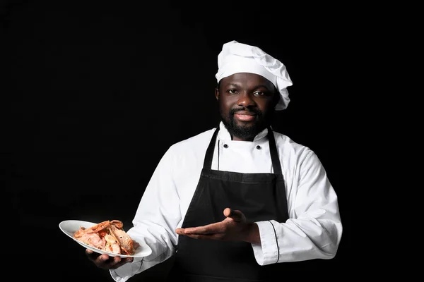 Chef Afroamericano Masculino Con Sabroso Plato Sobre Fondo Oscuro —  Fotos de Stock