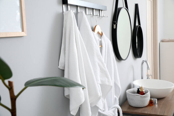 Hanger with clean towels in bathroom