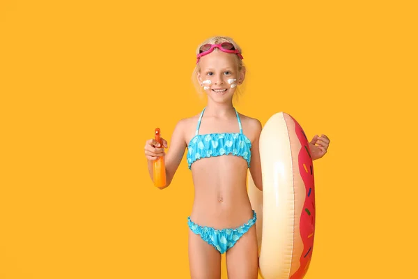 Little Girl Sun Protection Cream Inflatable Ring Color Background — Stock Photo, Image
