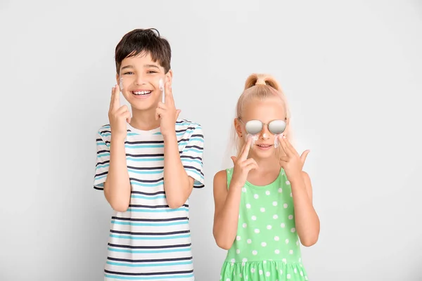 Little Children Sun Protection Cream Faces Grey Background — Stock Photo, Image