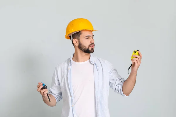 Young Man Measuring Tapes Light Background — Stock Photo, Image