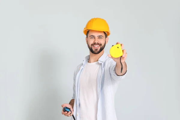 Young Man Measuring Tapes Light Background — Stock Photo, Image