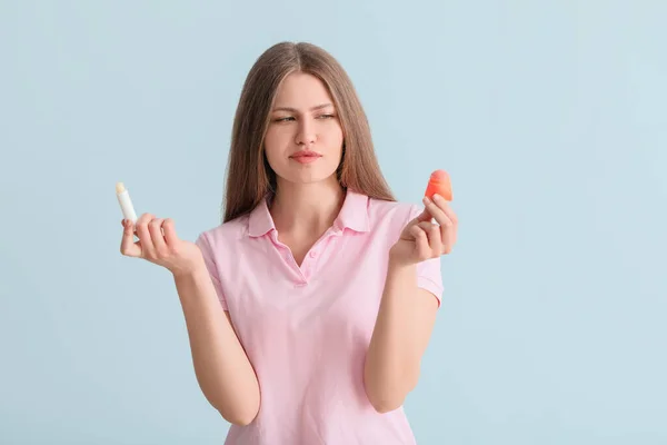 Beautiful Young Woman Lip Balms Light Background — Stock Photo, Image