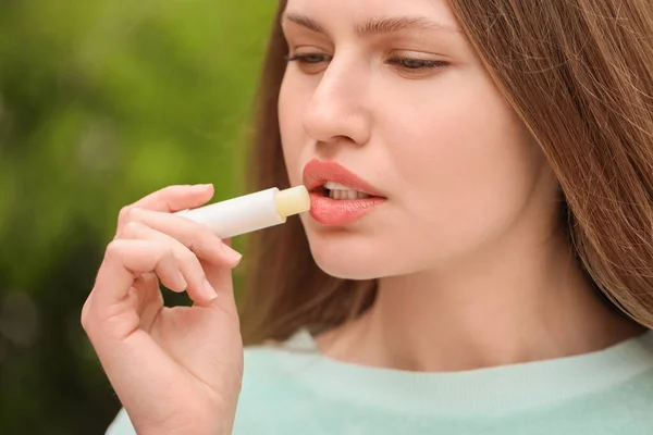 Beautiful Young Woman Lip Balm Outdoors — Stock Photo, Image