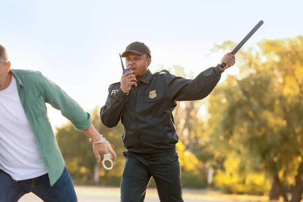 Aggressive African American Police Officer Mistreating Man Outdoors — Stock Photo, Image