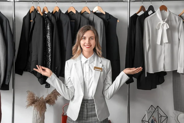 Female seller in modern clothes store