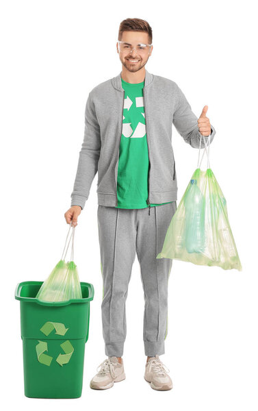 Man in t-shirt with recycling sign and trash on white background. Ecology concept