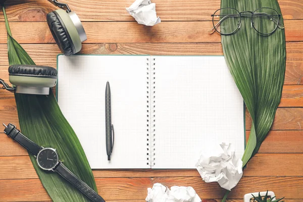 Composition with notebook on wooden background