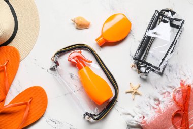 Beyaz arka planda güneş kremi olan plaj aksesuarları