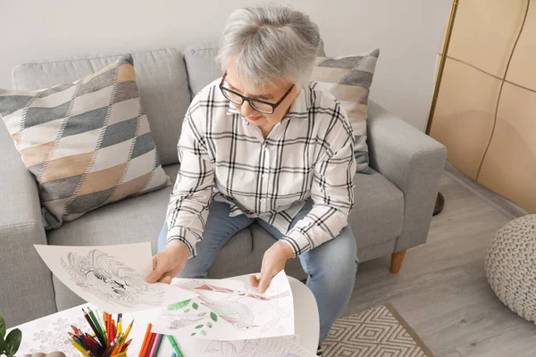 Senior woman coloring picture at home