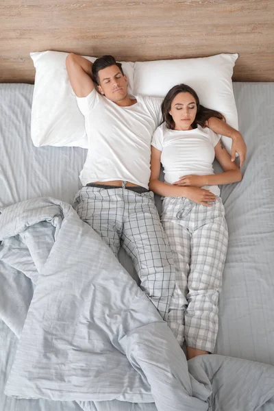 若いカップルのベッドで寝て トップビュー — ストック写真