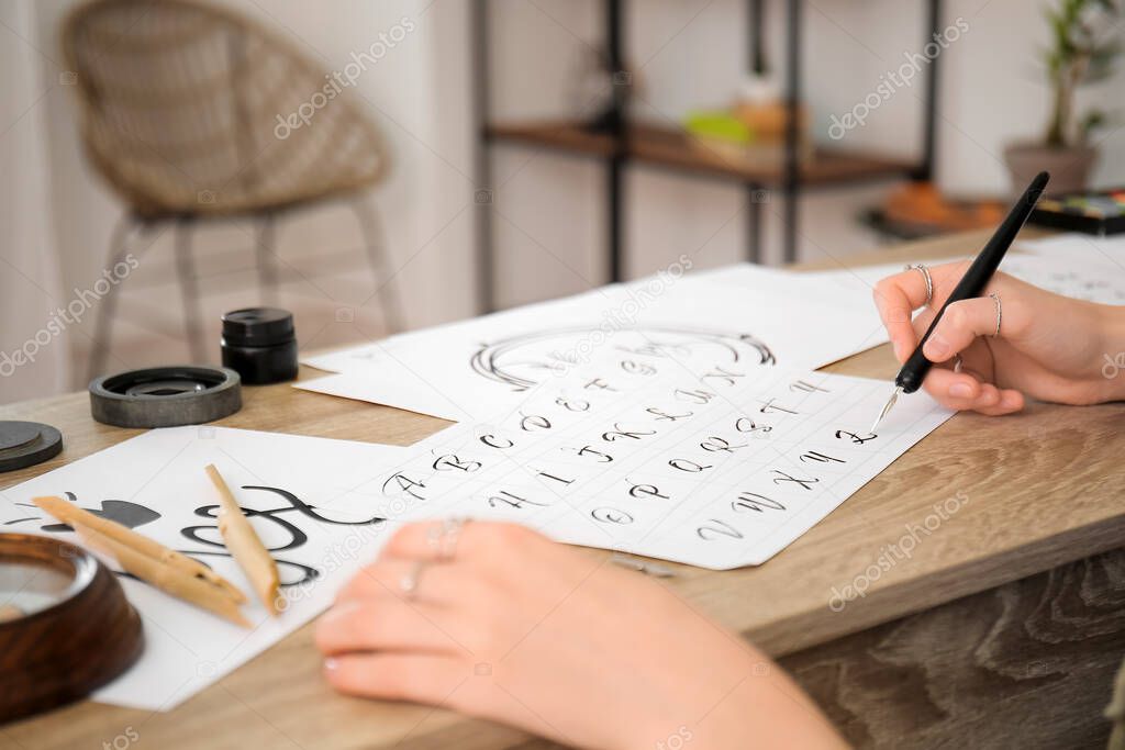 Female calligraphist working in office, closeup