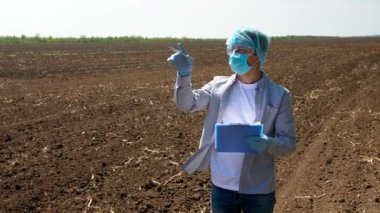 Bilim adamı sahadaki toprak örneklerini inceliyor