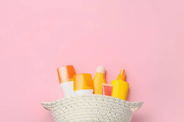 Bag with sunscreen cream on color background