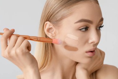 Yüzünde gri bir altyapısı olan güzel bir genç kadın.