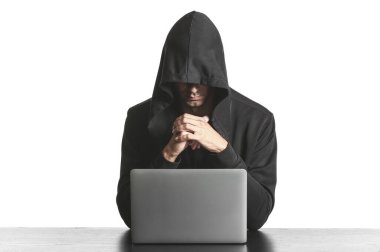 Masada dizüstü bilgisayarı beyaz arkaplana karşı kullanan profesyonel hacker.