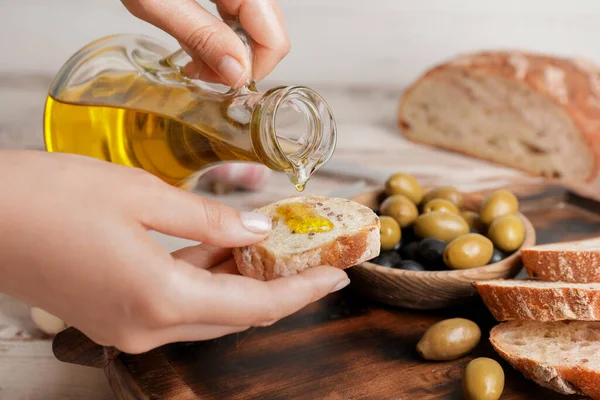 Woman Pouring Tasty Olive Oil Bread Slice Closeup — Stock Photo, Image