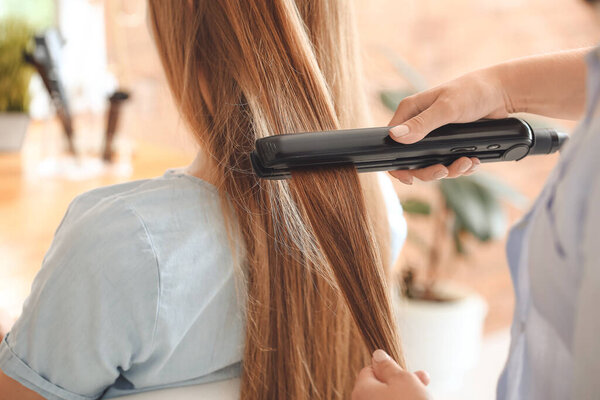 Hairdresser working with client in beauty salon