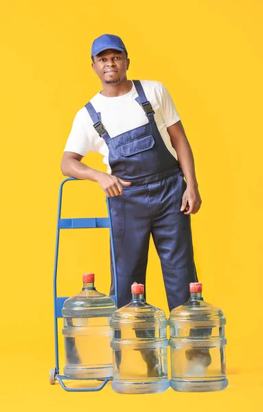 African American Delivery Man Bottles Water Color Background — Stock Photo, Image
