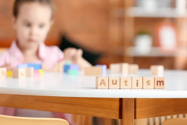 Wooden Cubes Word Autism Table Little Girl — Stock Photo, Image