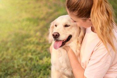 Parkta sevimli köpeği olan genç bir kadın.