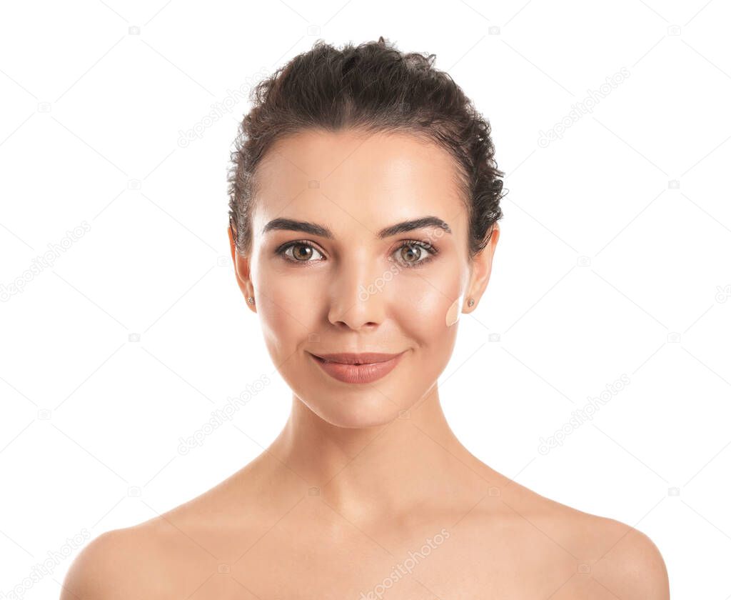Beautiful young woman with foundation on her face against white background