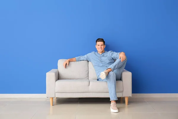 Young Man Relaxing Sofa Color Wall — Stock Photo, Image