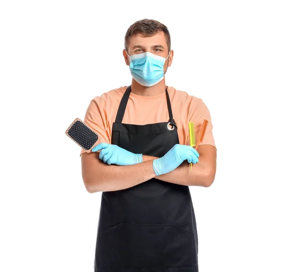 Male hairdresser wearing medical mask on white background. Coronavirus epidemic