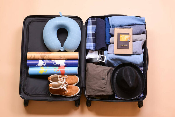 Packed suitcase on color background. Travel concept