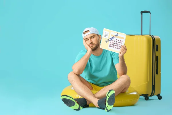 Sad Man Holding Calendar Written Word Quarantine Suitcase Color Background — Stock Photo, Image