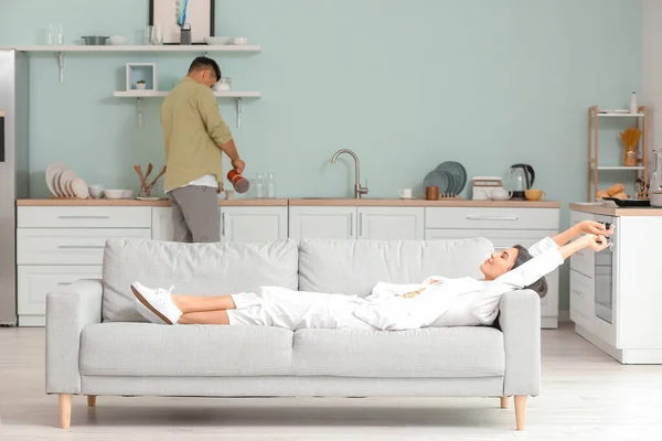 Young woman relaxing on sofa at home