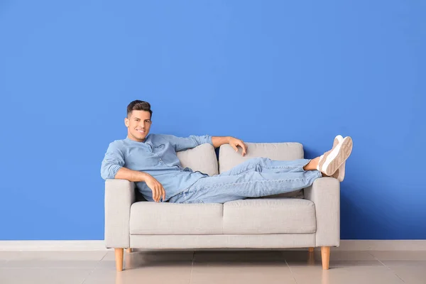 Young Man Relaxing Sofa Color Wall — Stock Photo, Image
