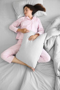 Yatakta uyuyan genç bir kadın.