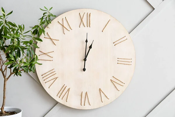 Işık duvarının yanında saatli ev bitkisi